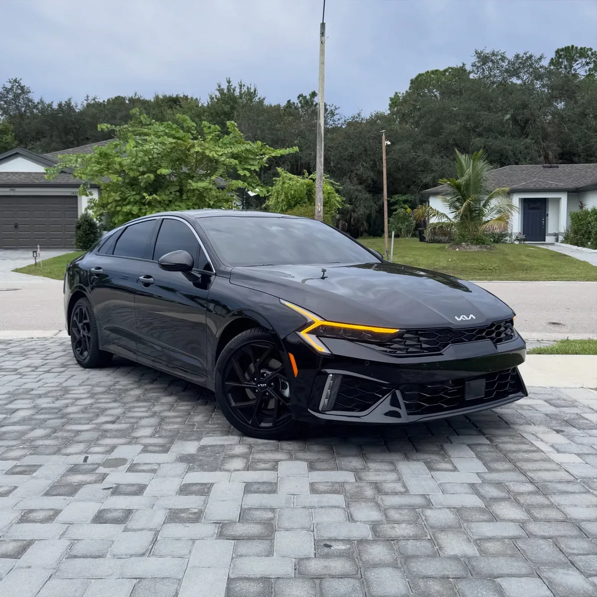 Black Kia sedan with dark ceramic tint